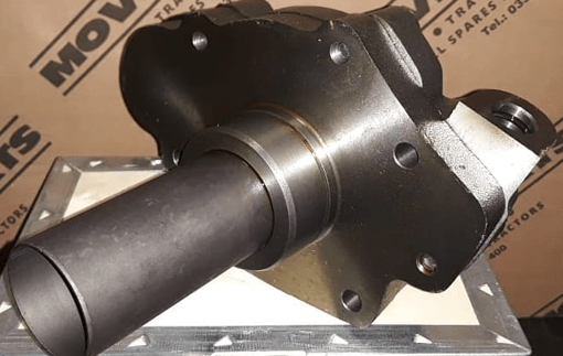 A replacement tractor part sitting on a box.
